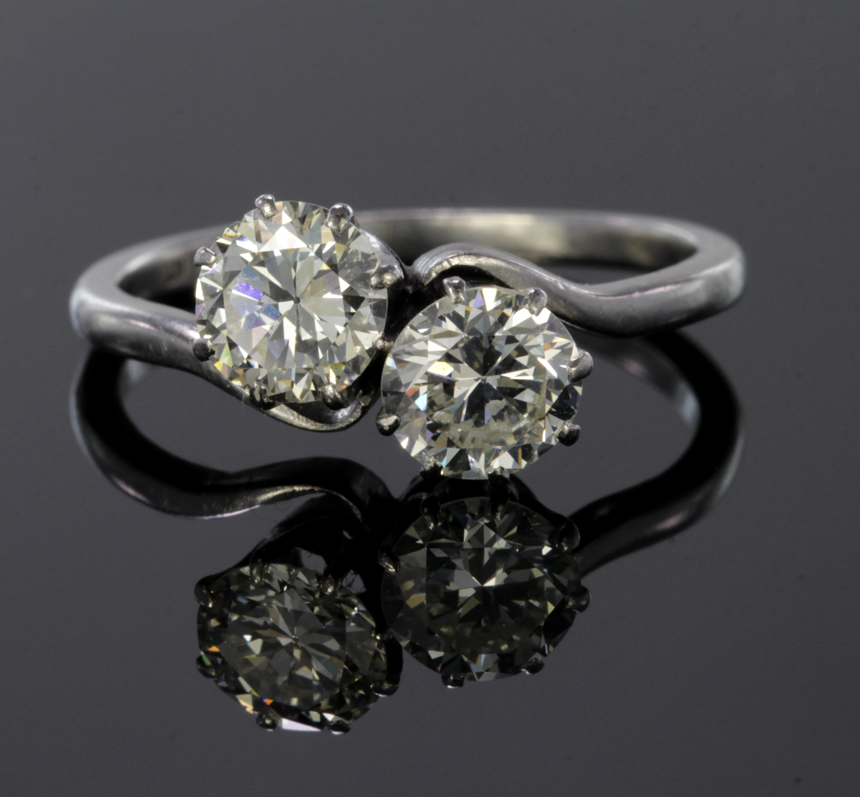 Platinum ring set with two diamonds, each calculated to weigh approx. 0.75ct. Finger size M,