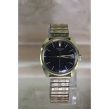 Gents gold plated Longines wristwatch. The black dial with white baton markers and date aperture