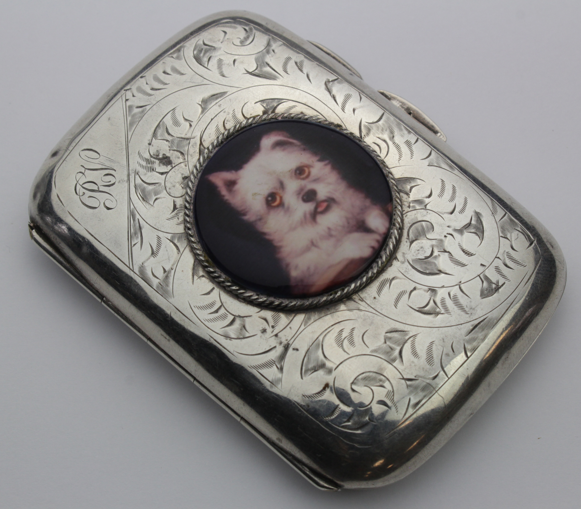 Silver and enamel cigarette case, with enamel image of a dog to lid (West Highland Terrier ?),