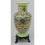 Chinese celadon vase, ornately decorated, on a metal three legged base, total height 27.5cm approx.