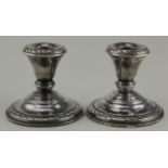 Pair of loaded dwarf silver candlesticks (probably American) . Marked on the bases "Arnston Sterling