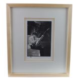 George Harrison, a scarce 8 x 10" photograph of him cleaning his guitar, in the early 1960’s,