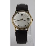 Gents 9ct cased wristwatch by Tissot. The silvered dial with black/gilt baton markers and date