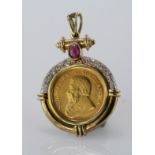 Yellow gold pendant mount set with diamonds and single cabochon ruby, holding a 1994 quarter