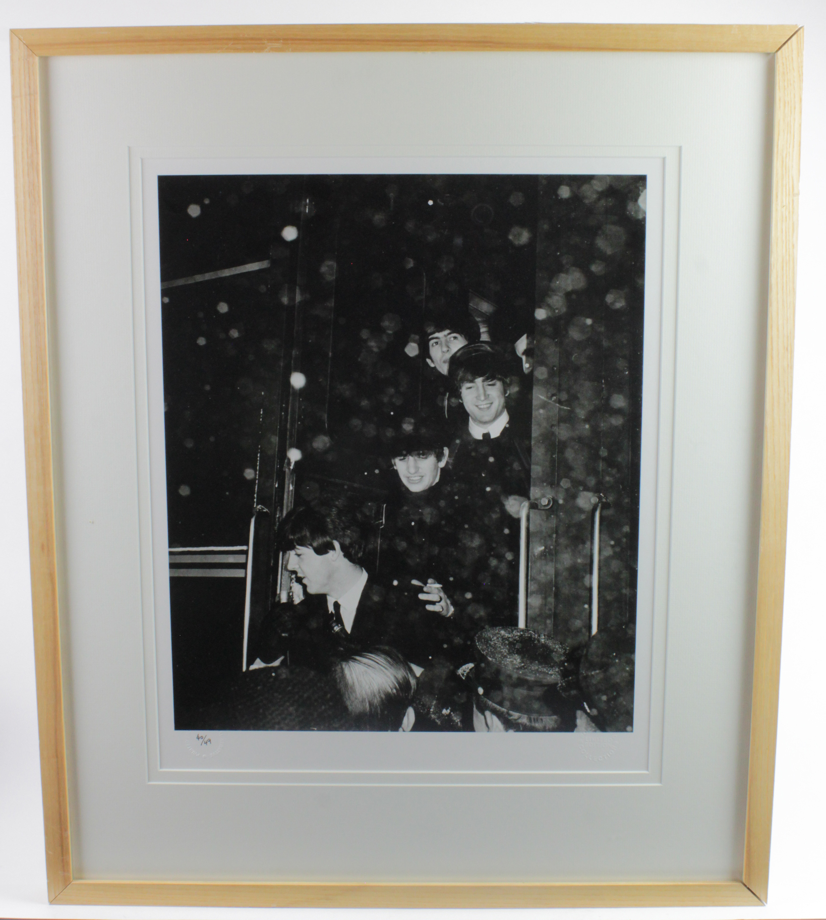 The Beatles, a 16 x 20" photograph of the them getting off a train, in the 1960’s, taken from the