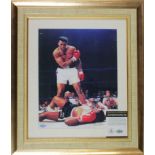 Framed 10 x 8 Muhammed Ali/Sonny Liston image signed by Ali later in his life across the chest. An