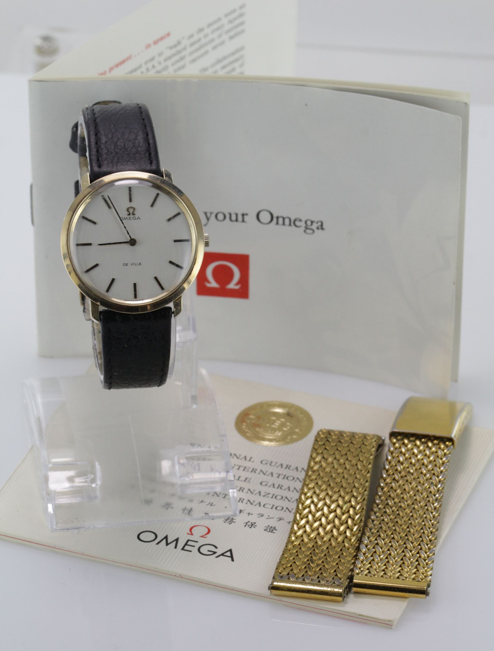 Gents 9ct cased Omega Deville. The round cream dial with gilt baton markers, on an Omega leather