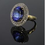 18ct yellow gold cluster ring set with AAA quality oval Tanzanite weighing 9.27ct, surrounded by a
