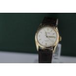 Gents 14ct cased Rolex wristwatch model no. 6085. The crean dial with gilt arabic/ baton markers. On