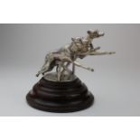 Greyhound interest. A silver Glasgow hallmarked trophy depicting two racing greyhounds jumping a