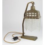 Lamp. A brass Art Nouveau style table lamp, with cloth interior & glass drops, height 32cm approx.
