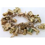 Heavy 9ct / yellow metal charm bracelet with a good selection of charms attached, total weight 86g