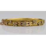 9ct yellow gold hollow hinged bangle with box clasp and safety chain, set with diamond rubies and