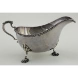 Silver sauce boat with three attractive legs, one of which is bent. Hallmarked Birm. 1961. Weighs