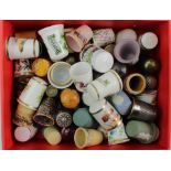 Thimbles. A large collection of approximately sixty thimbles, including brass, ceramic & white metal