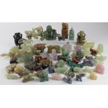 Ornaments. A large collection of miniature figures / statues, depicting buddhas, rabbits, dragons,