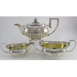 George III oblong silver teapot, silver milk jug and matching silver sugar basin. Teapot semi-