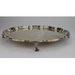 Silver salver with pie crust rim, raised on four feet, hallmarked Birmingham 1940 by G Bryan & Co.