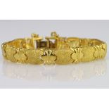 High carat yellow gold bracelet with textured links, foldover clasp and safety chain, weight 39.2g