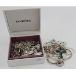 Assortment of silver / white metal jewellery in a Pandora box, includes charms , pendants ,