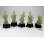 Jade. A group of five Chinese Jade figures, each with wooden stand (one figure damaged), height 10cm