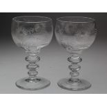 Pair' of early glasses with engraved floral decoration, each with a double knopped stem, height 13cm