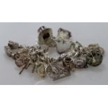 Very heavy Silver / white metal charm bracelet with a good variety of charms attached, total