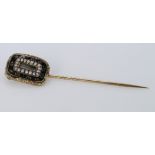19th Century yellow metal mourning brooch (later made into a hat pin). The black and gold surround