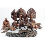 Nine carved indian Ornaments, including Lions, a Buddha, a male & female bust, fish, etc.