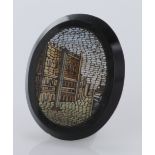 A 19thC Grand Tour Oval Micro-mosaic plaque. Embedded into black stone. Measures approx 3.5cm x 4cm