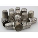 Fifteen white metal thimbles, many with ornate decoration