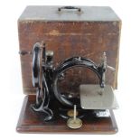 Willcox & Gibbs sewing machine on an oak base, height 25cm, length 33cmcm approx. contained in a