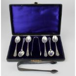 Six silver matching teaspoons and sugar tongs, hallmarked 'W.D, Birmingham 1906', contained original