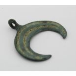 Viking circa 900 AD enammelled bronze lunar pendant, 30-25mm