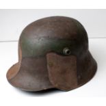 Imperial German M16 Stalhelm steel helmet with camo paint finish, surface rusting in places but a