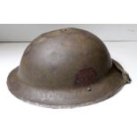 British WW2 Brodie Helmet MkII with service / combat dents to crown, painted Combined Ops badge in
