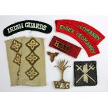 Badges - shoulder titles in metal and cloth, noted 'ENSA' Welsh Guards, Div patch, etc. (9)