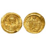 Justinian I 527-565 A.D., gold solidus, obverse:- Helmeted and cuirassed bust facing, holding