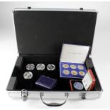 Small assortment of encapsulated coins / modern boxed issues in an Aluminium case. Includes Silver