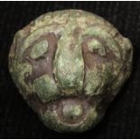 Small bronze panthers head, c.22mm., evidently once had a fixing at back, green-black patina,