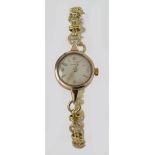 Ladies gold plated Omega wristwatch hallmarked circa 1956. The cream dial with gilt arabic / baton