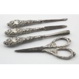 Attractive four piece silver mounted manicure set, all have unusual decorated heads on them, all