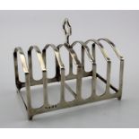 Silver toast rack hallmarked for Adie Bros. Birmingham 1926. Weighs 3.75oz.