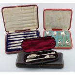 Four boxed sets comprising six silver teaspoons and six silver handled tea knives, both sets