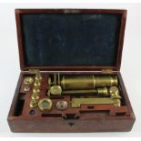 Victorian brass folding microscope, by J. P. Cutts, London, with additional lenses etc., contained