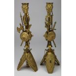 Candlesticks. A pair of unusal gilt metal Medieval style candlesticks, ornately decorated with