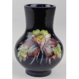 Moorcroft small vase, with floral decoration, original printed label to base, height 10.5cm approx.