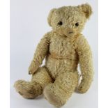 Large Merrythought teddy bear with label to foot & button to ear, circa early 20th Century, length
