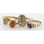 Four 9ct gold gem set solitaire rings to include citrine, smoky quartz, amethyst and moss agate,