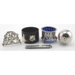 Four silver items and one silver mounted cow horn napkin ring. The also includes an unmarked